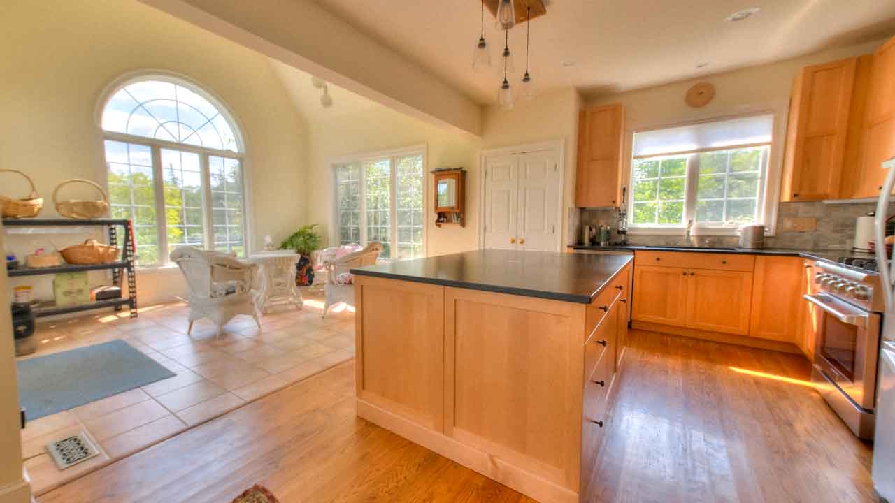 Cheval Noir open kitchen adjacent to the sunroom with modern design and ample space