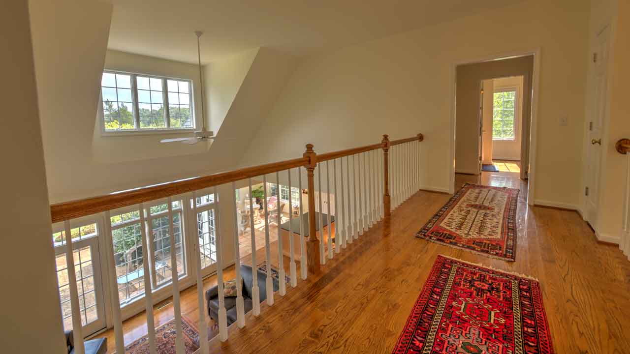 Upstairs landing at Cheval Noir overlooking the great room with an open, airy feel